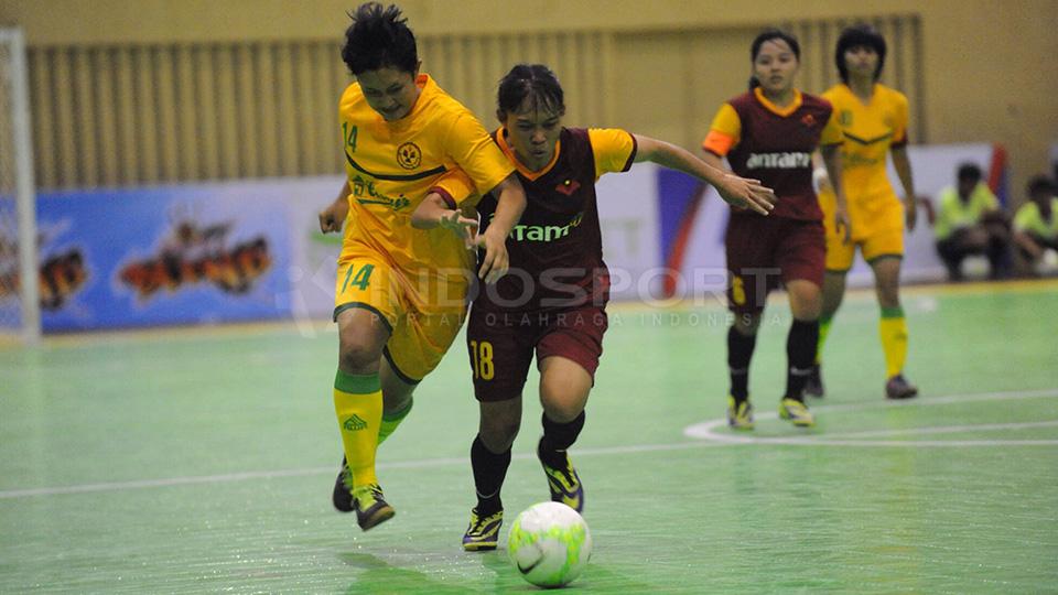 Rebutan Bola. Nur Fajriah (No 14) dari tim futsal putri UNJ Jakarta berusaha merebut bola dari pemain UPI Tia Darti Septiawati (No 18) pada laga AFF Club Futsal Chamnpionship 2015 di Istora Senayan, Jakarta. Sabtu (17/01/2015).